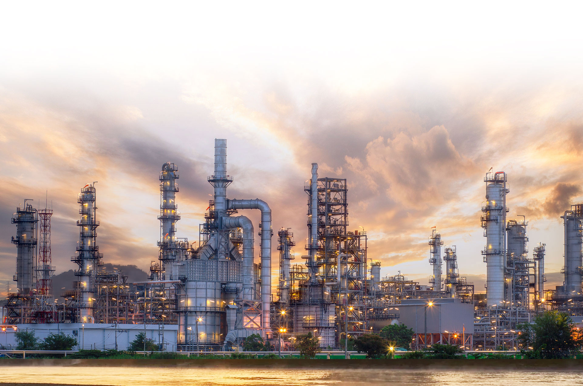 Refinery at sunset beside the water